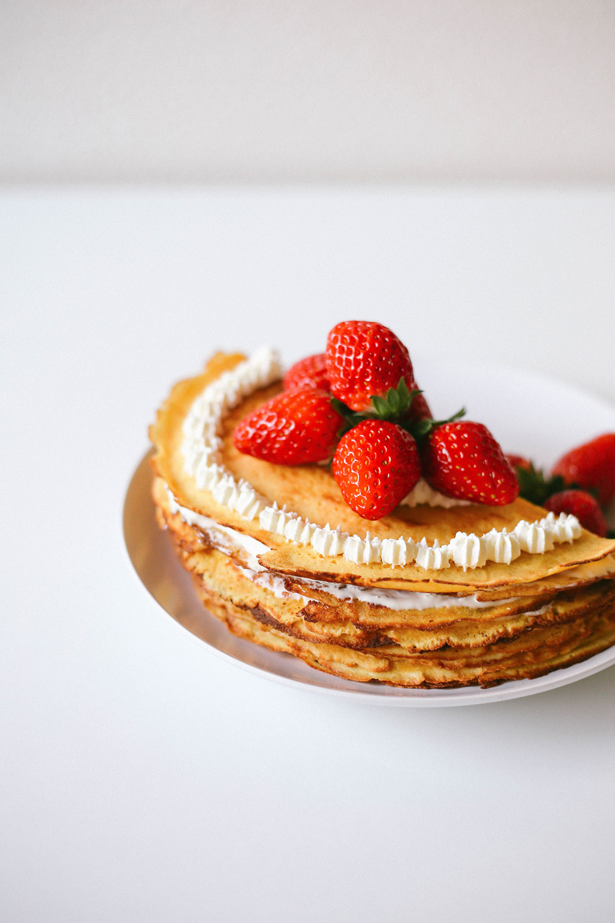 Keto crepe cake for low carb. Easy mille crepe recipe served with strawberries.